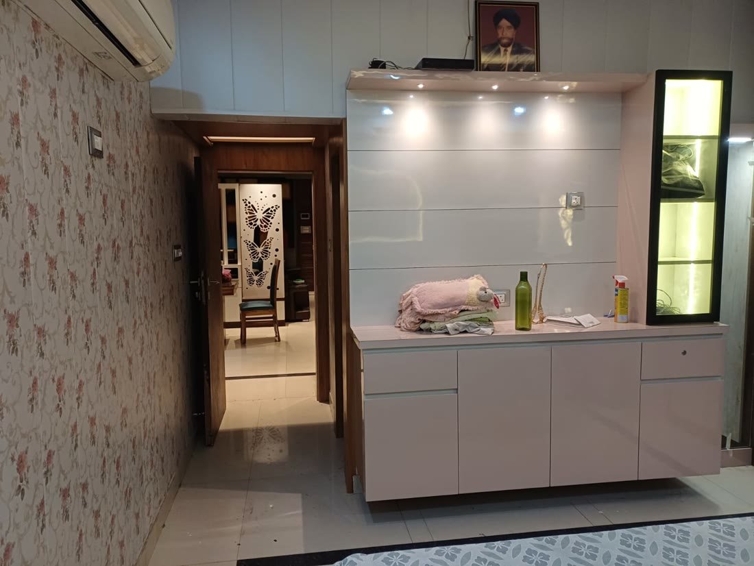 Pink cabinet unit with lit glass display case, hallway interior