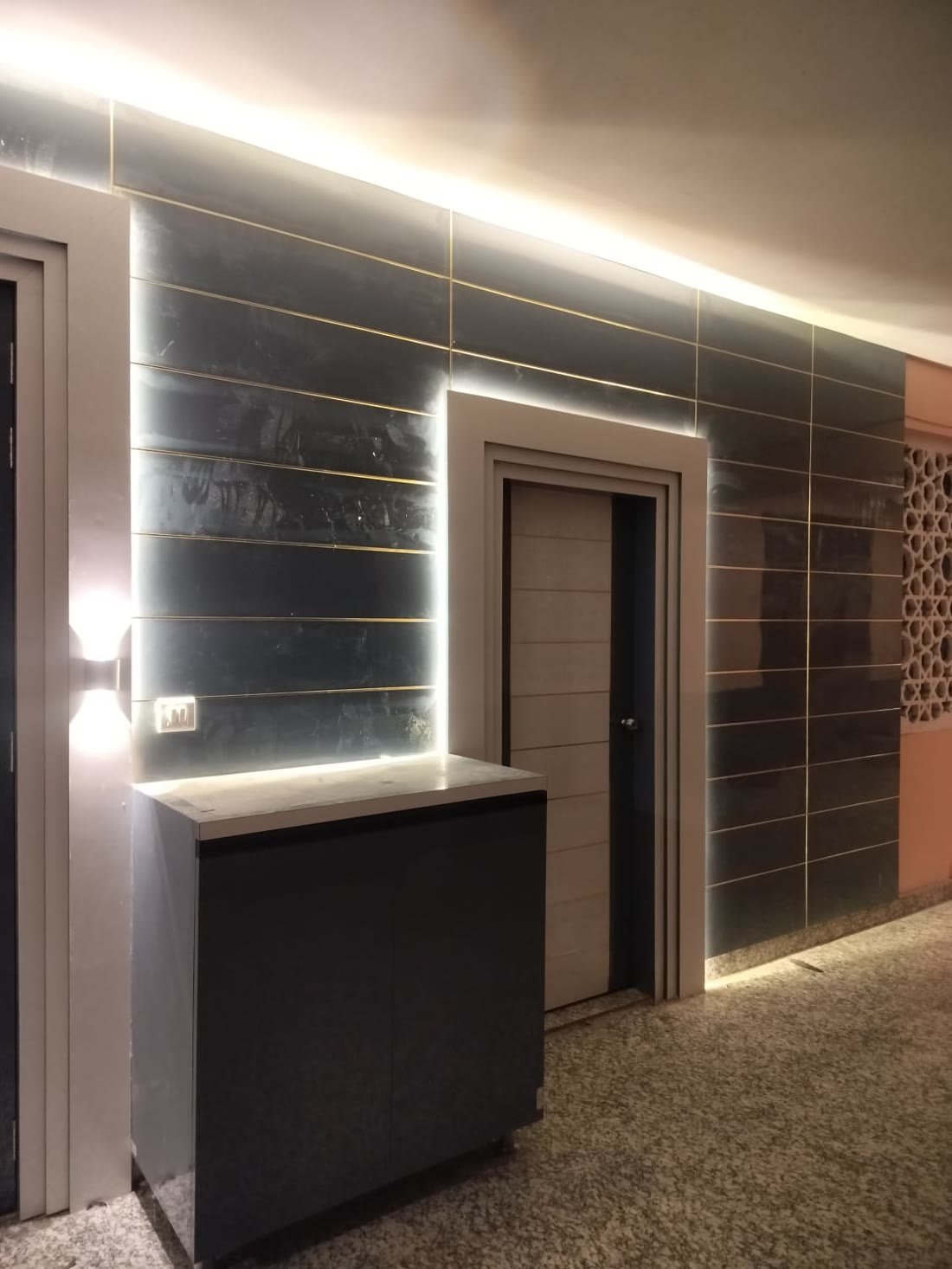 Dark wall panelling corridor with backlit gold trim detailing