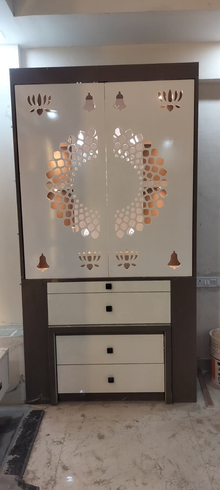 Pooja mandir unit with jaali cutout lotus and bell design, closed